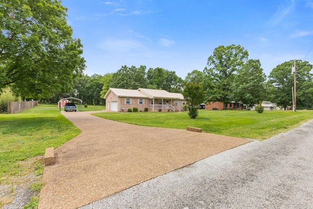 111 Hickory Trce, Lyles, TN 37098 - view of front of property featuring a garage, driveway, a detached carport, brick siding, and view of wooded area