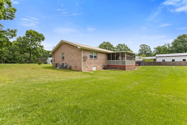 111 Hickory Trce, Lyles, TN 37098 - back of house featuring a sunroom, brick siding, and central AC