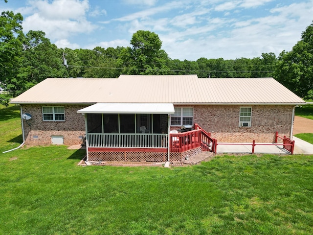 111 Hickory Trce, Lyles, TN 37098 - rear view of house with brick siding, a sunroom, and a lawn