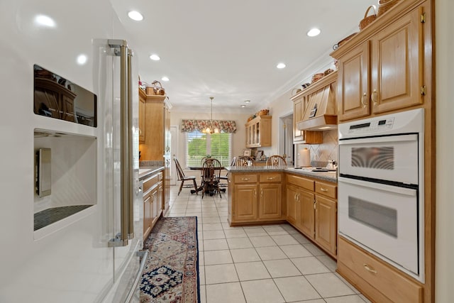 2039 Sparta Pike, Lebanon, TN 37090 - kitchen with double oven, crown molding, a peninsula, light tile patterned flooring, and a chandelier