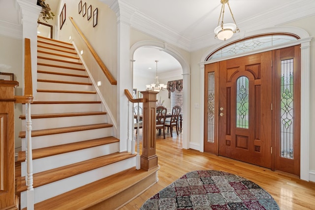 2039 Sparta Pike, Lebanon, TN 37090 - foyer featuring a chandelier, stairway, wood finished floors, arched walkways, and crown molding