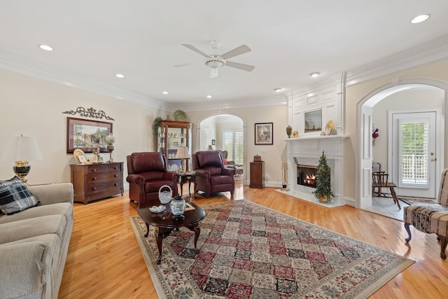 2039 Sparta Pike, Lebanon, TN 37090 - living area with arched walkways, healthy amount of natural light, ornamental molding, a ceiling fan, and light wood-style floors