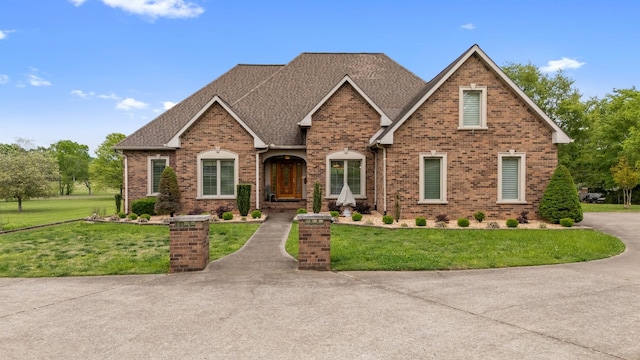 2039 Sparta Pike, Lebanon, TN 37090 - view of front of house with a front yard, brick siding, and a shingled roof