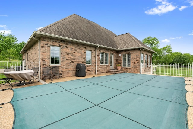 2039 Sparta Pike, Lebanon, TN 37090 - rear view of house featuring brick siding, a shingled roof, fence, and a patio area