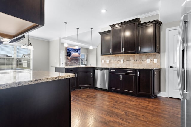 201 Josie Ln, Clarksville, TN 37043 - kitchen with stainless steel appliances, dark wood finished floors, tasteful backsplash, a peninsula, and ornamental molding