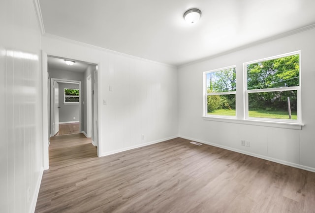 2705 Thrush Dr, Clarksville, TN 37040 - empty room with crown molding, plenty of natural light, wood finished floors, and baseboards