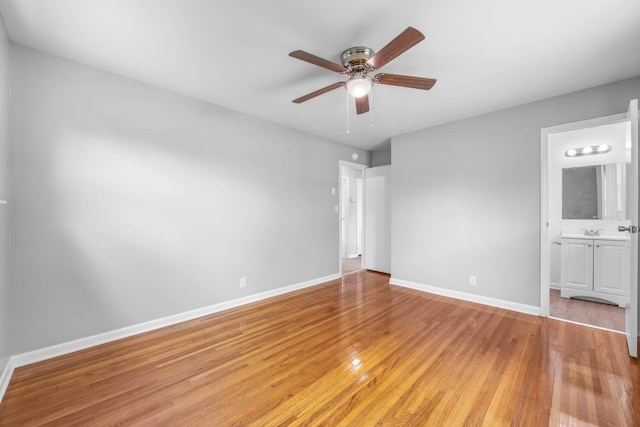 2705 Thrush Dr, Clarksville, TN 37040 - unfurnished bedroom featuring light wood-type flooring, baseboards, ensuite bath, and a ceiling fan