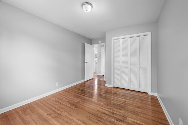 2705 Thrush Dr, Clarksville, TN 37040 - unfurnished bedroom with a closet, wood finished floors, and baseboards