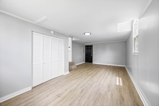 2705 Thrush Dr, Clarksville, TN 37040 - unfurnished living room featuring attic access, wood finished floors, and baseboards
