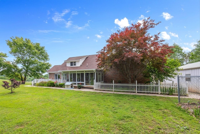 rear view of property featuring a sunroom