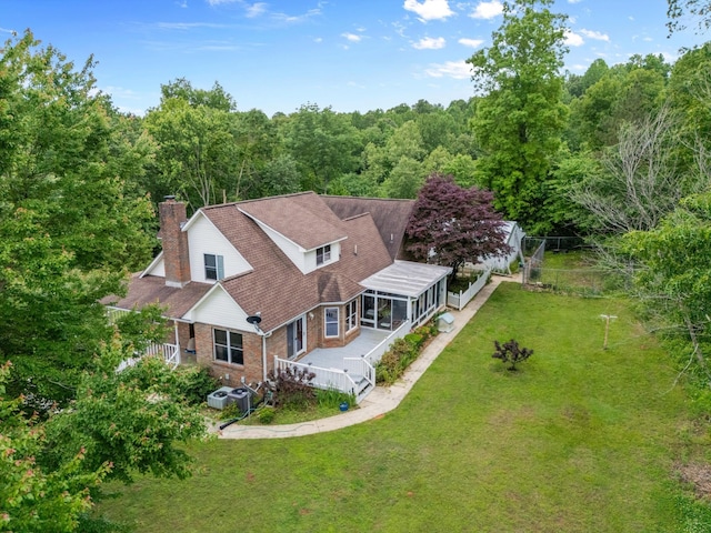 aerial view of property and surrounding area featuring a forest