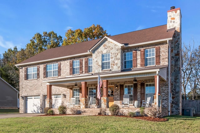 1032 Neeleys Bnd, Spring Hill, TN 37174 - view of front facade with covered porch, a garage, a chimney, brick siding, and driveway