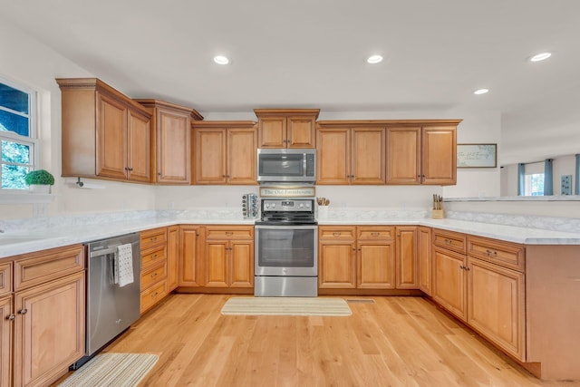 1032 Neeleys Bnd, Spring Hill, TN 37174 - kitchen with stainless steel appliances, light countertops, a peninsula, light wood-style flooring, and recessed lighting