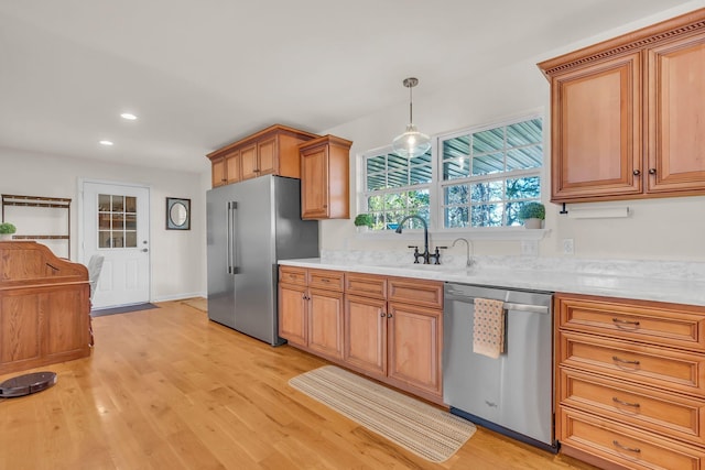 1032 Neeleys Bnd, Spring Hill, TN 37174 - kitchen featuring appliances with stainless steel finishes, light countertops, a sink, light wood-style flooring, and recessed lighting