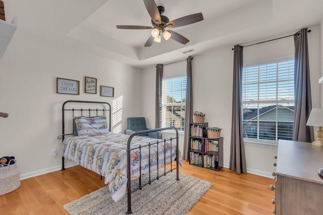 1032 Neeleys Bnd, Spring Hill, TN 37174 - bedroom featuring a raised ceiling, light wood-style floors, baseboards, and a ceiling fan