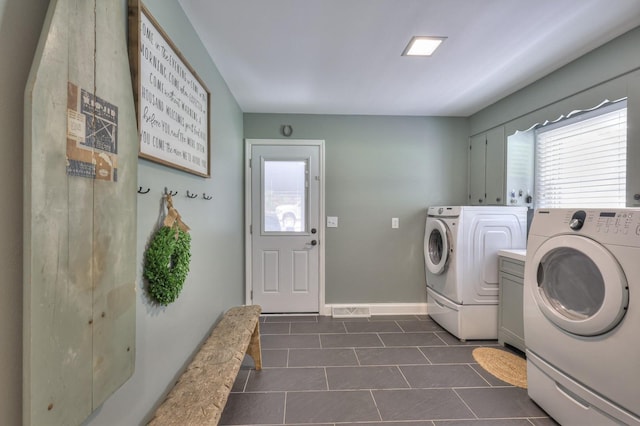 1880 E Compton Rd, Murfreesboro, TN 37130 - laundry area featuring washer and clothes dryer, dark tile patterned floors, baseboards, and cabinet space