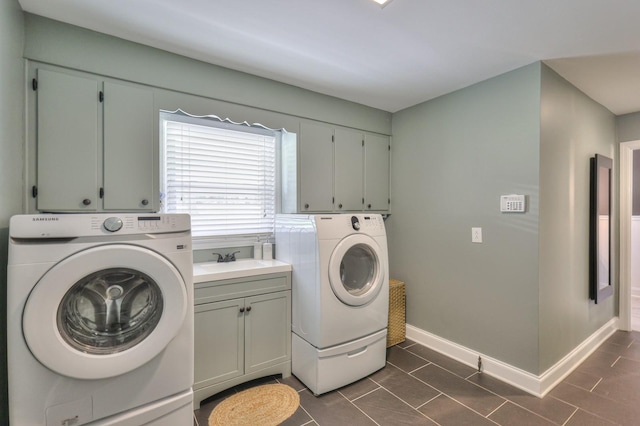 1880 E Compton Rd, Murfreesboro, TN 37130 - laundry room with washing machine and dryer, cabinet space, dark tile patterned floors, and baseboards