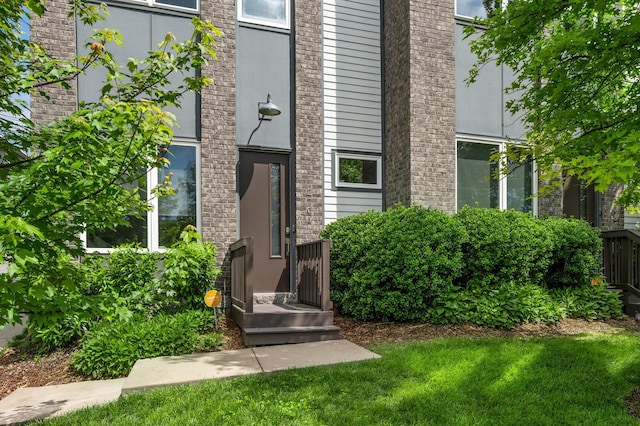 doorway to property with a lawn