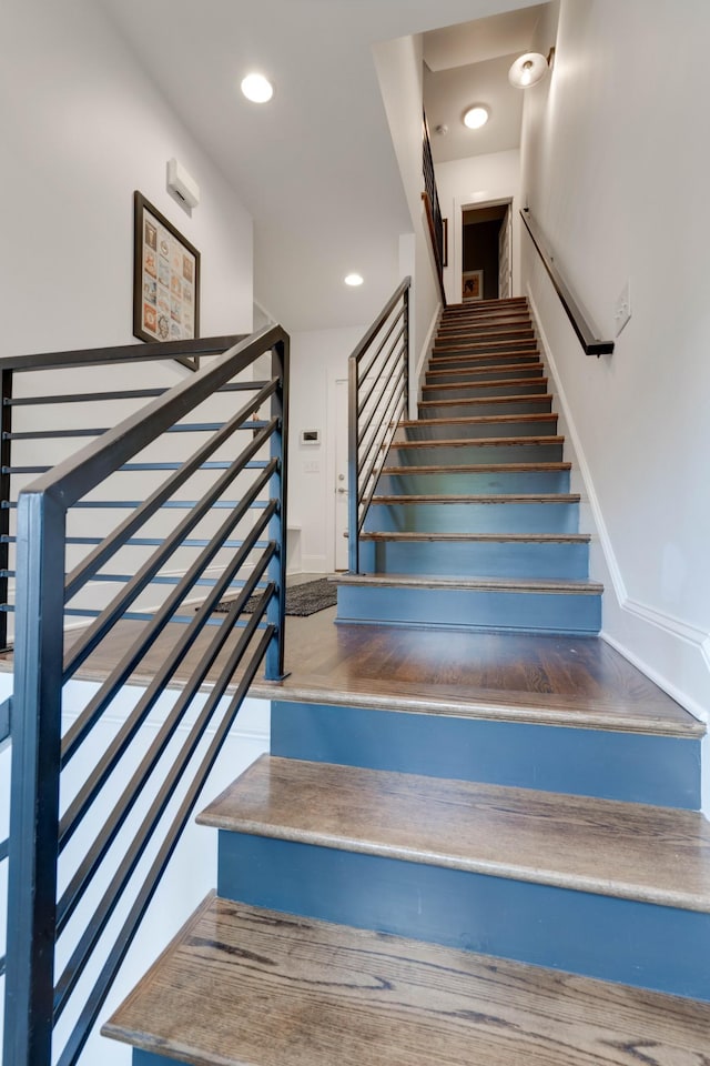 staircase with baseboards and recessed lighting