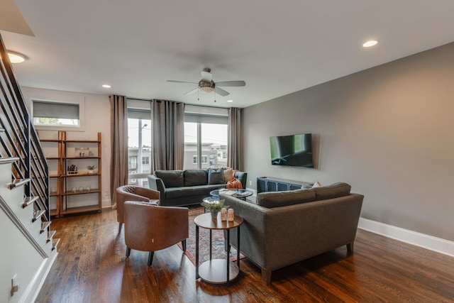 living area featuring a ceiling fan, wood finished floors, baseboards, stairway, and recessed lighting