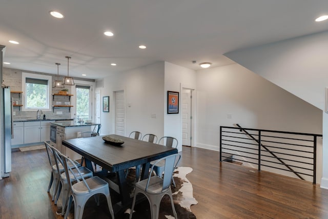 dining room featuring dark wood finished floors, recessed lighting, and baseboards