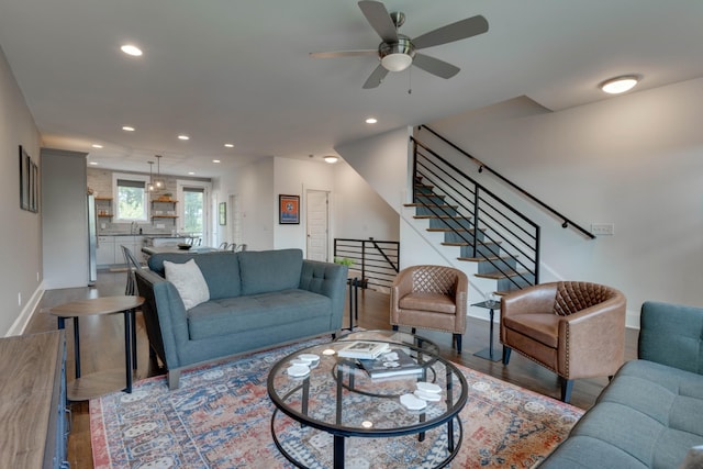 living room with recessed lighting, ceiling fan, baseboards, wood finished floors, and stairs