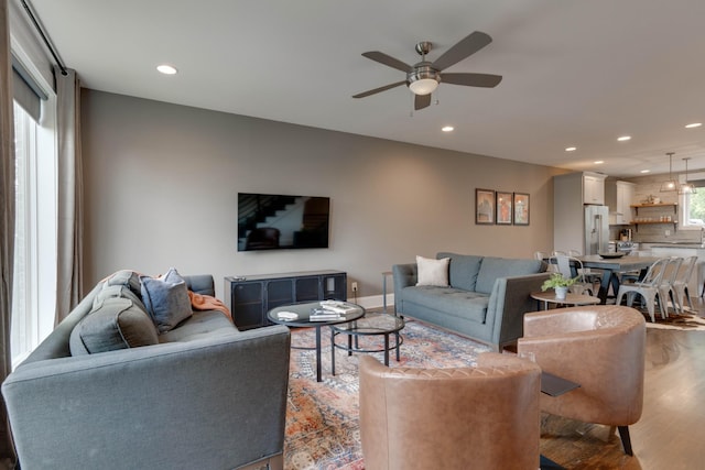 living room with wood finished floors, ceiling fan, and recessed lighting