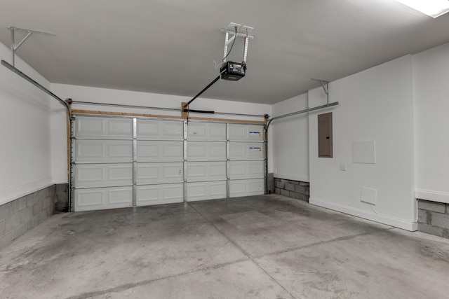 garage featuring electric panel and a garage door opener