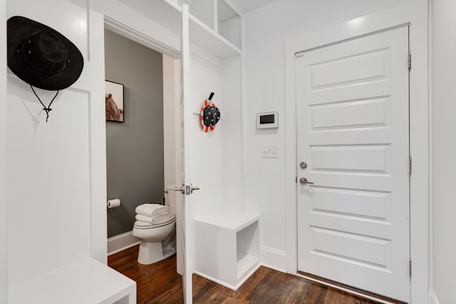mudroom with dark wood-type flooring and baseboards
