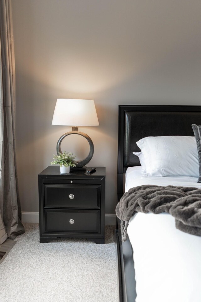 bedroom with carpet floors and baseboards