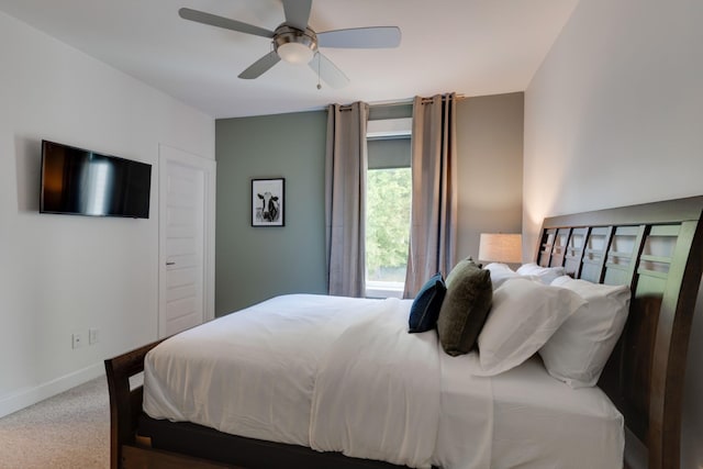 carpeted bedroom with baseboards and ceiling fan