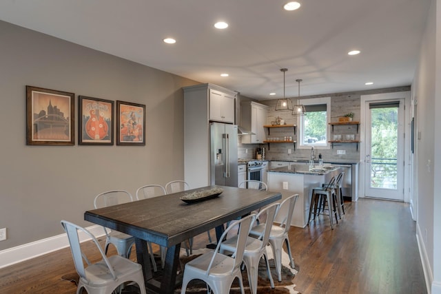 dining room with recessed lighting, dark wood-style flooring, and baseboards