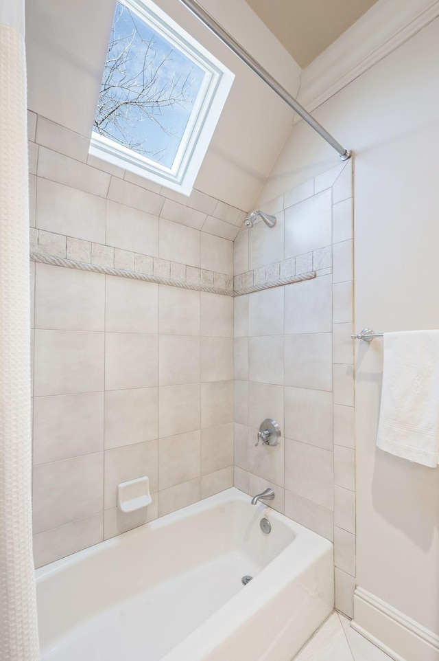 bathroom with a skylight, shower / tub combo, and lofted ceiling
