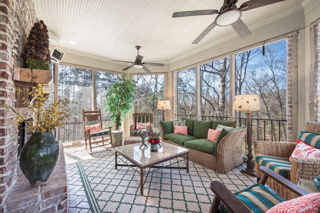sunroom with a ceiling fan and an outdoor hangout area