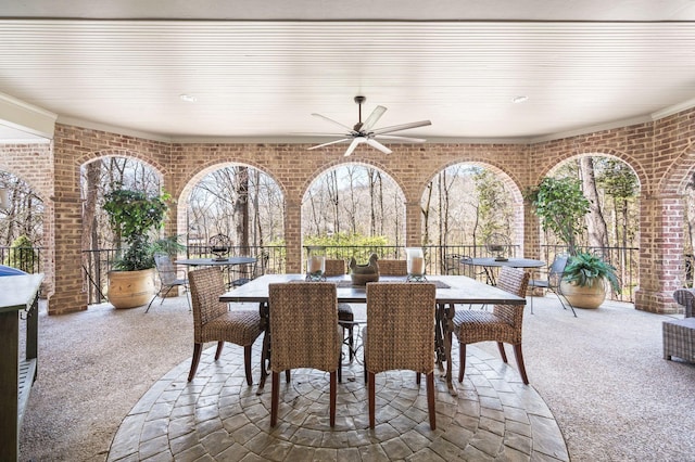 view of patio featuring outdoor dining area and a ceiling fan