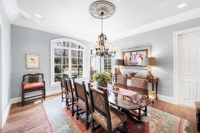 dining space featuring a chandelier, baseboards, hardwood / wood-style floors, crown molding, and recessed lighting