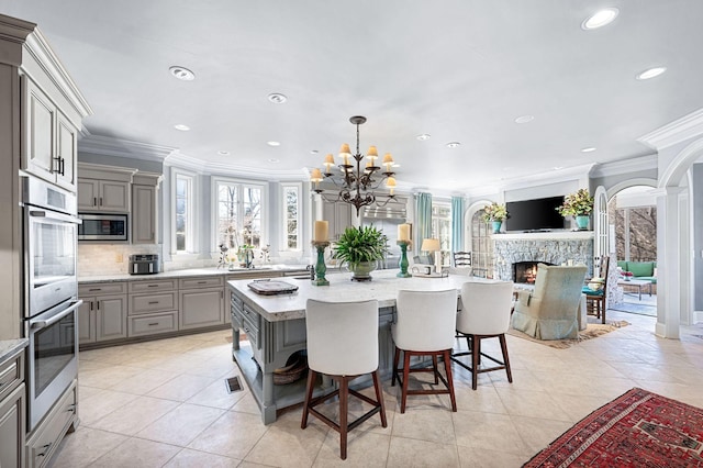 kitchen featuring gray cabinets, appliances with stainless steel finishes, ornamental molding, recessed lighting, and tasteful backsplash