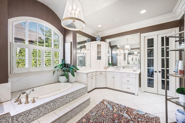 bathroom featuring a garden tub, vanity, tile patterned floors, ornamental molding, and french doors