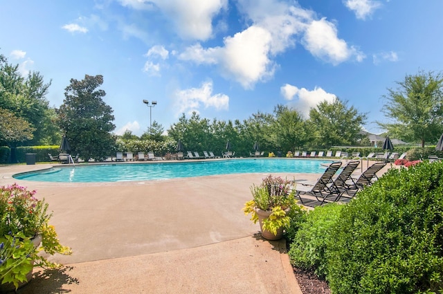 community pool with a patio area