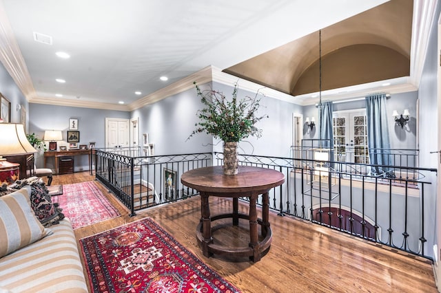 hallway featuring an upstairs landing, wood finished floors, recessed lighting, and crown molding