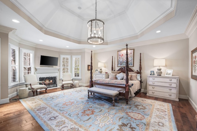 bedroom with a chandelier, dark wood-type flooring, a warm lit fireplace, baseboards, and recessed lighting