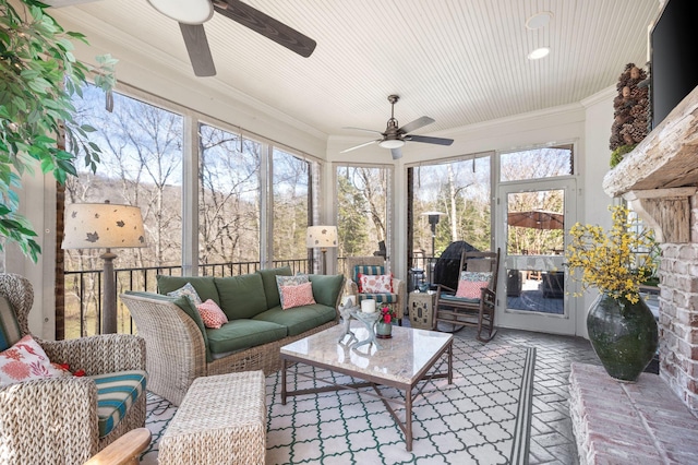 sunroom / solarium with ceiling fan and an outdoor living space