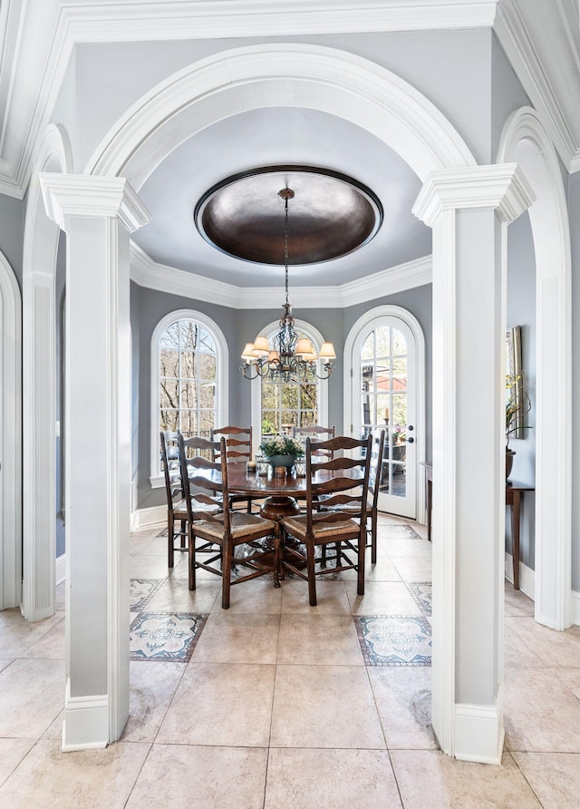 dining area featuring ornate columns, arched walkways, healthy amount of natural light, and crown molding