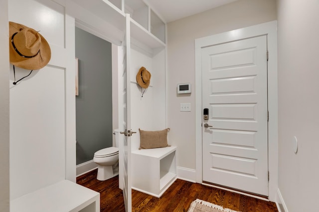 mudroom with dark wood-type flooring and baseboards