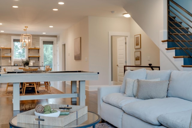 living area featuring recessed lighting, stairs, a chandelier, wood finished floors, and baseboards