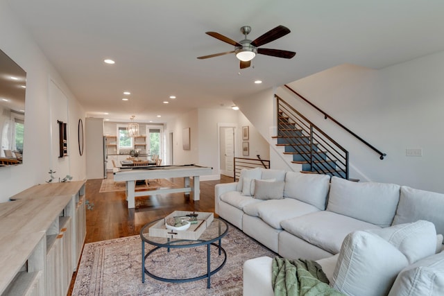 living room featuring wood finished floors, recessed lighting, ceiling fan, and stairs