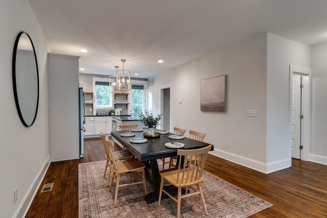 dining area featuring dark wood-style floors, a chandelier, recessed lighting, and baseboards