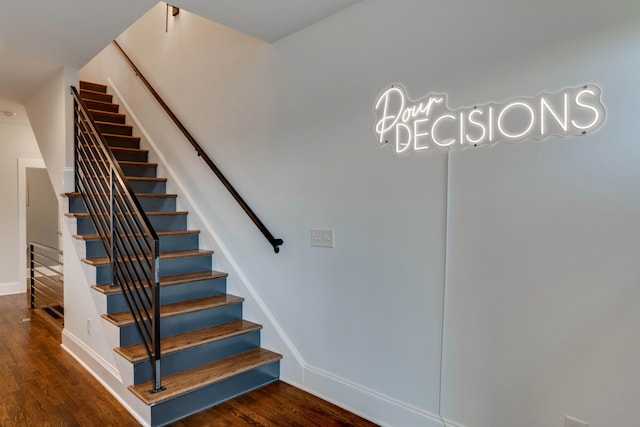 stairs featuring wood finished floors and baseboards