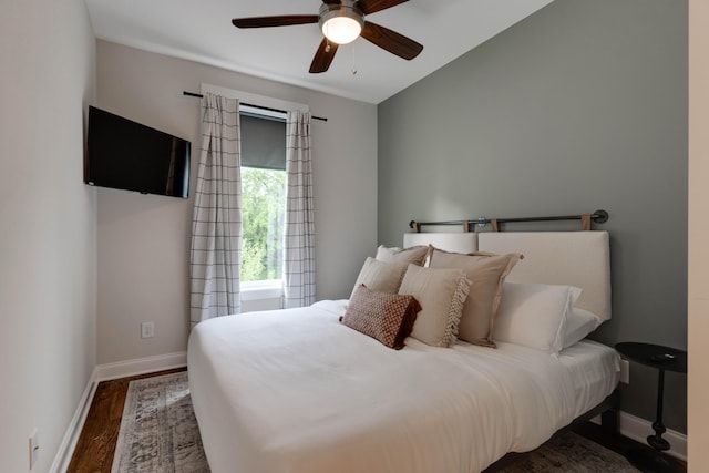 bedroom with wood finished floors, baseboards, and ceiling fan
