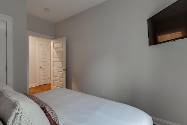 bedroom with baseboards and light wood-style flooring